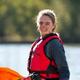 Sarah Miller, outdoor enthusiast, smiling with her kayak gear